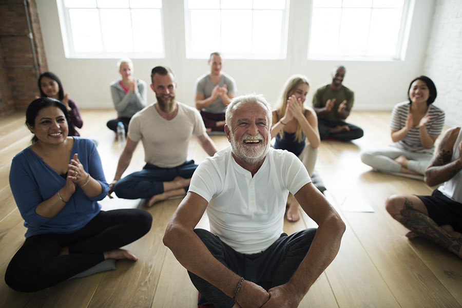 Employee Benefits - Group of Happy People Attending a Yoga Class